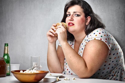 obese woman eating junk food